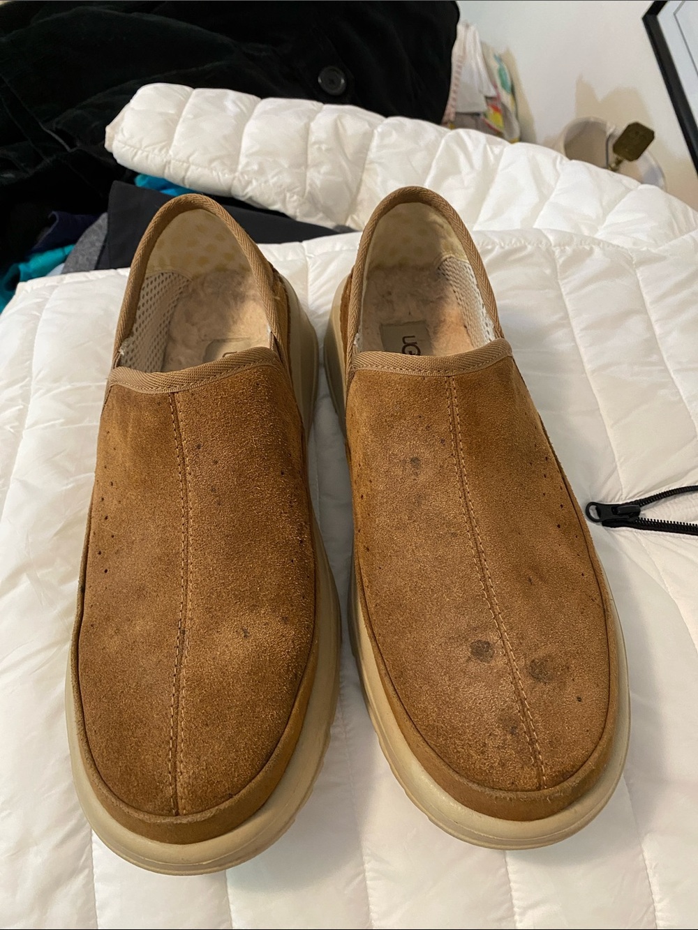 UGG men’s slippers. Supportive slippers with anti-skid bottoms and heel cups.